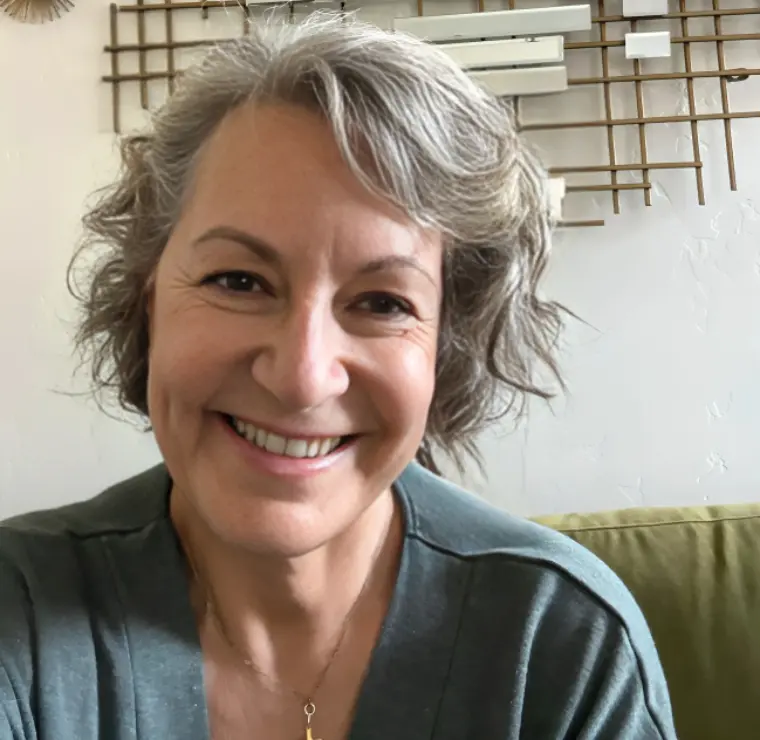 New Project(4) Smiling person with short gray hair indoors.