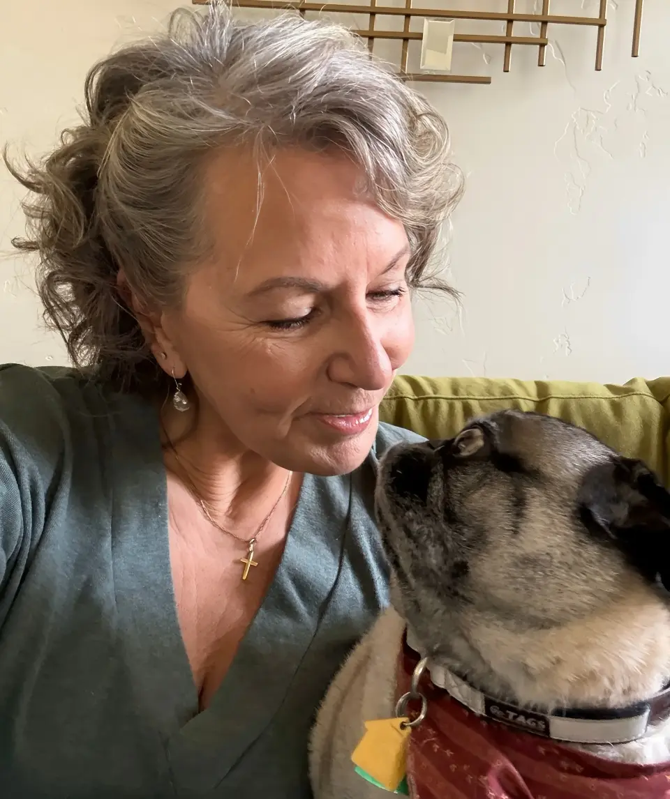 Woman smiling at her dog lovingly.